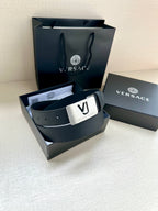 Dark blue belt with square metal VJ logo buckle and perforated strap