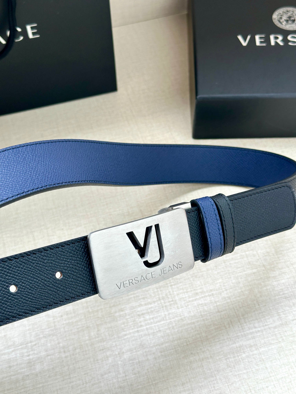 Blue Versace belt with silver square buckle plate and stitched strap edge detail