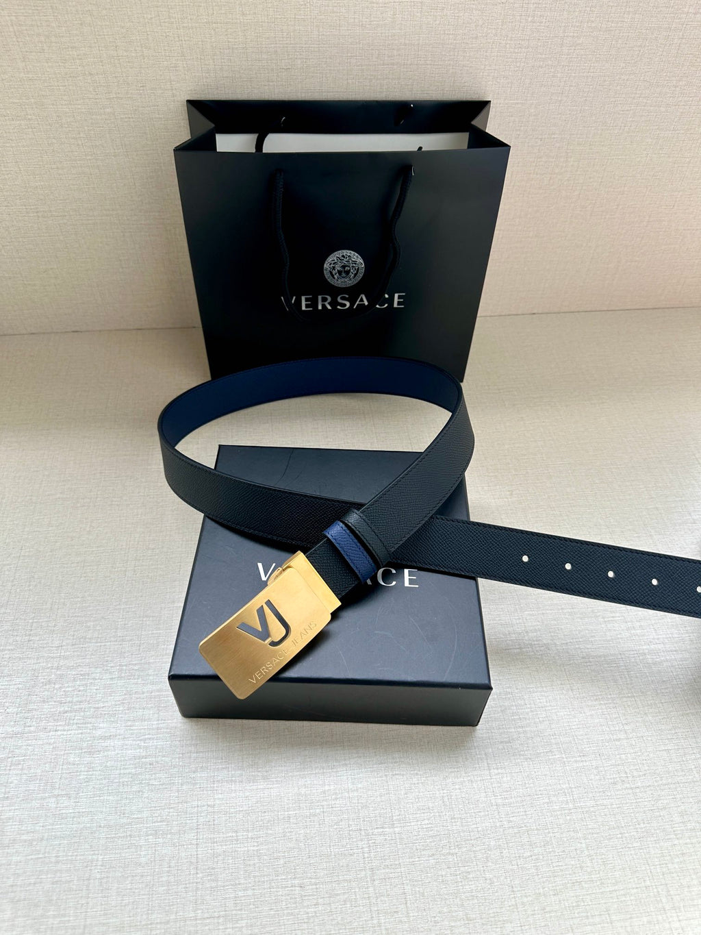 Versace blue leather belt with gold square buckle and silver-toned logo plate