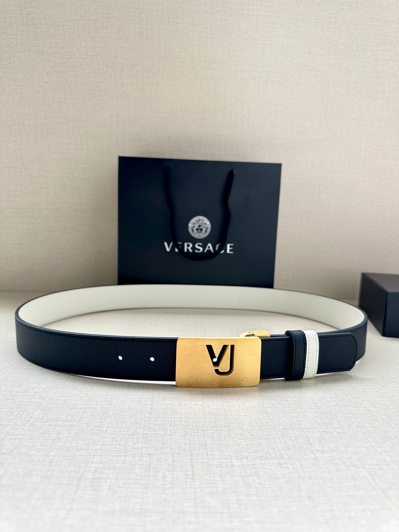 Versace belt in dark navy with white edge stripe and gold VJ logo buckle