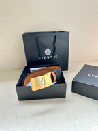 Versace belt with dark leather strap, tan underside, gold square VJ buckle.