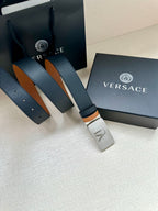 Versace belt with dark leather strap, tan underside, silver VJ buckle and holes.
