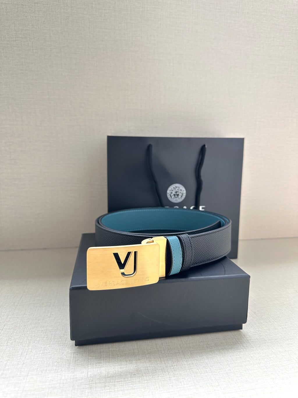Two-tone leather belt with gold square buckle and VJ logo on turquoise strap