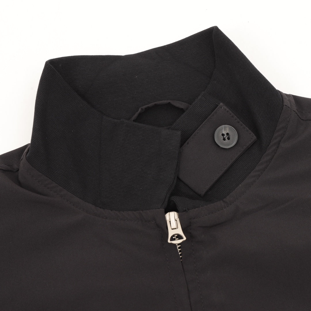 Stone Island jacket collar with snap tab, half-zip pull, textured black fabric