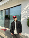 Black lightweight jacket with stand collar, patch pocket, and zip front