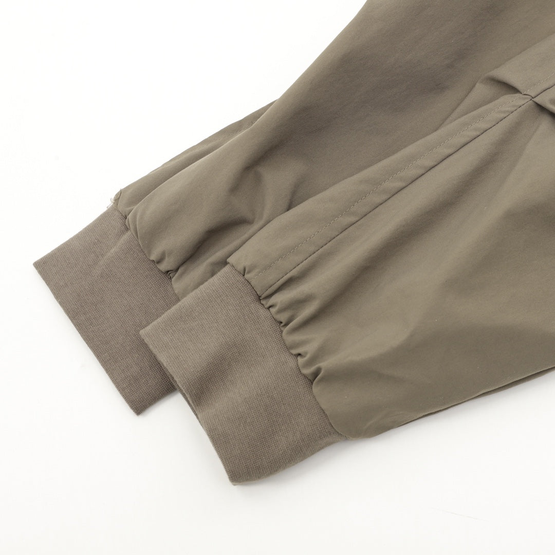 Olive bomber jacket sleeve with elastic seam and ribbed cuff