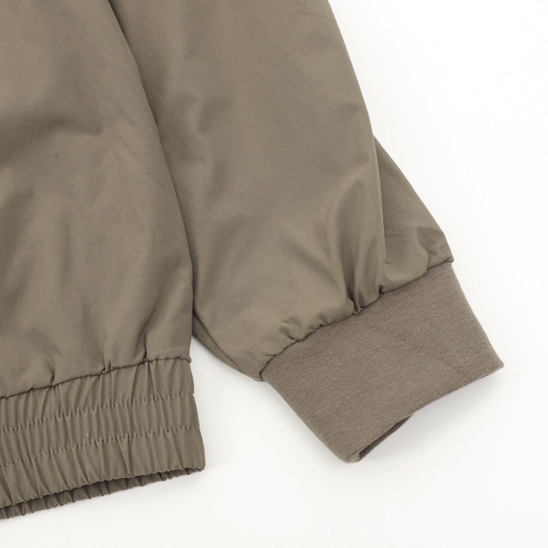 Olive bomber jacket sleeve with ribbed cuff and elasticated hem