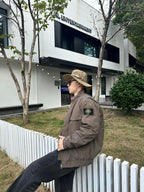 Stone Island taupe jacket in side profile, shoulder patch visible