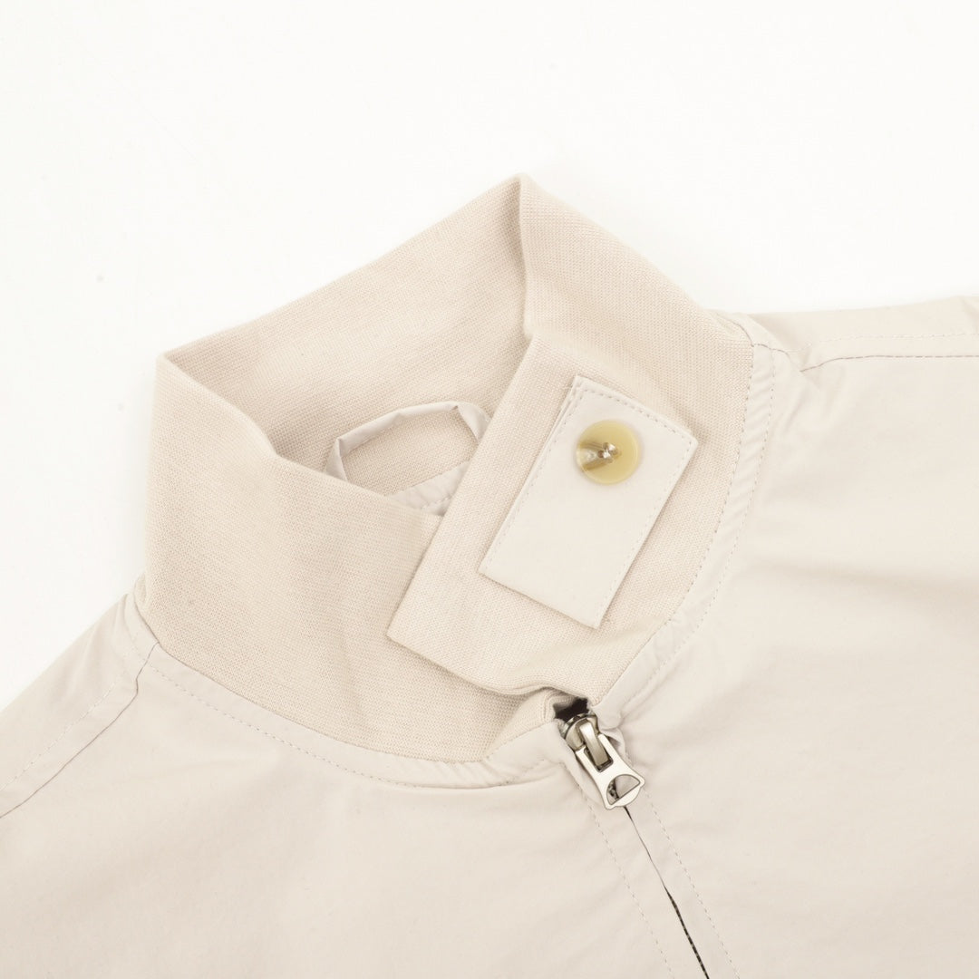 Light beige jacket with snap collar detail and visible front zipper hardware