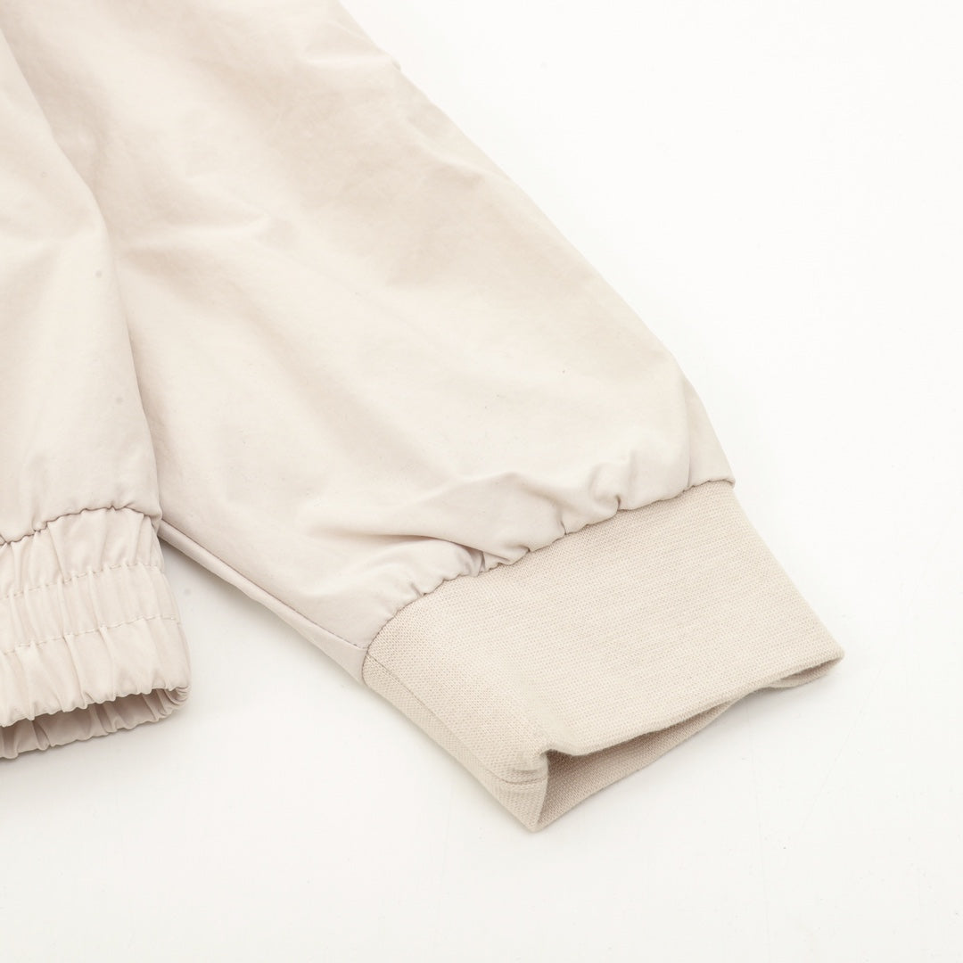 Light beige jacket sleeve cuff with ribbed elastic and elasticated hem