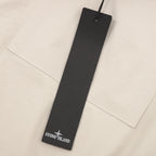 Stone Island size tag hanging on cream jacket front