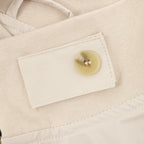 Stone Island jacket close-up: beige button and fabric tag