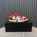 Red and white Amiri sneakers with leopard print accents and red laces