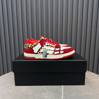 Red and white Amiri sneakers with leopard print accents and red laces