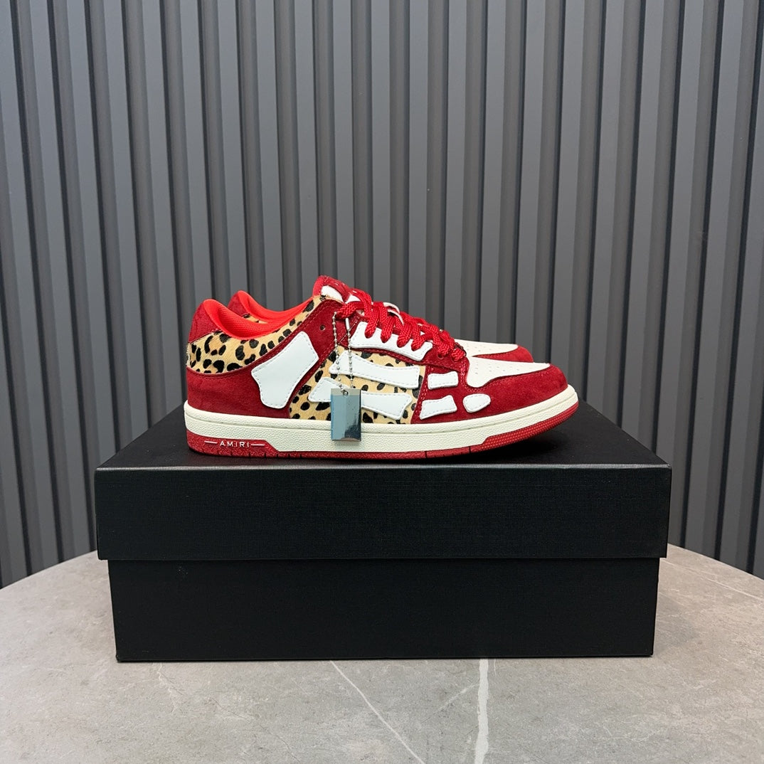 Red and white Amiri sneakers with leopard print accents and red laces