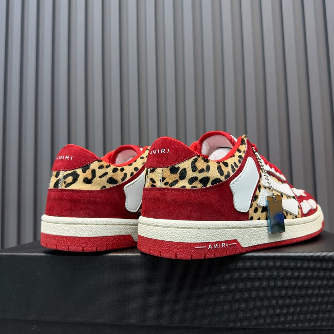 Red and white Amiri sneakers with leopard heel panels and hanging tag