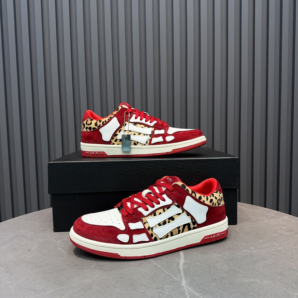 Red and white Amiri sneakers with leopard side panels, front view