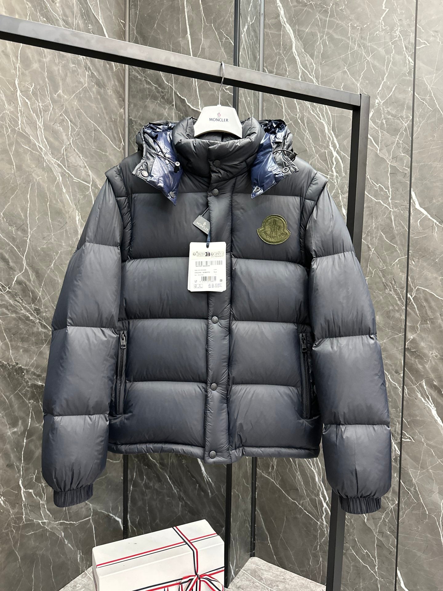 Long hooded puffer jacket, dark gray quilted with logo badge on chest