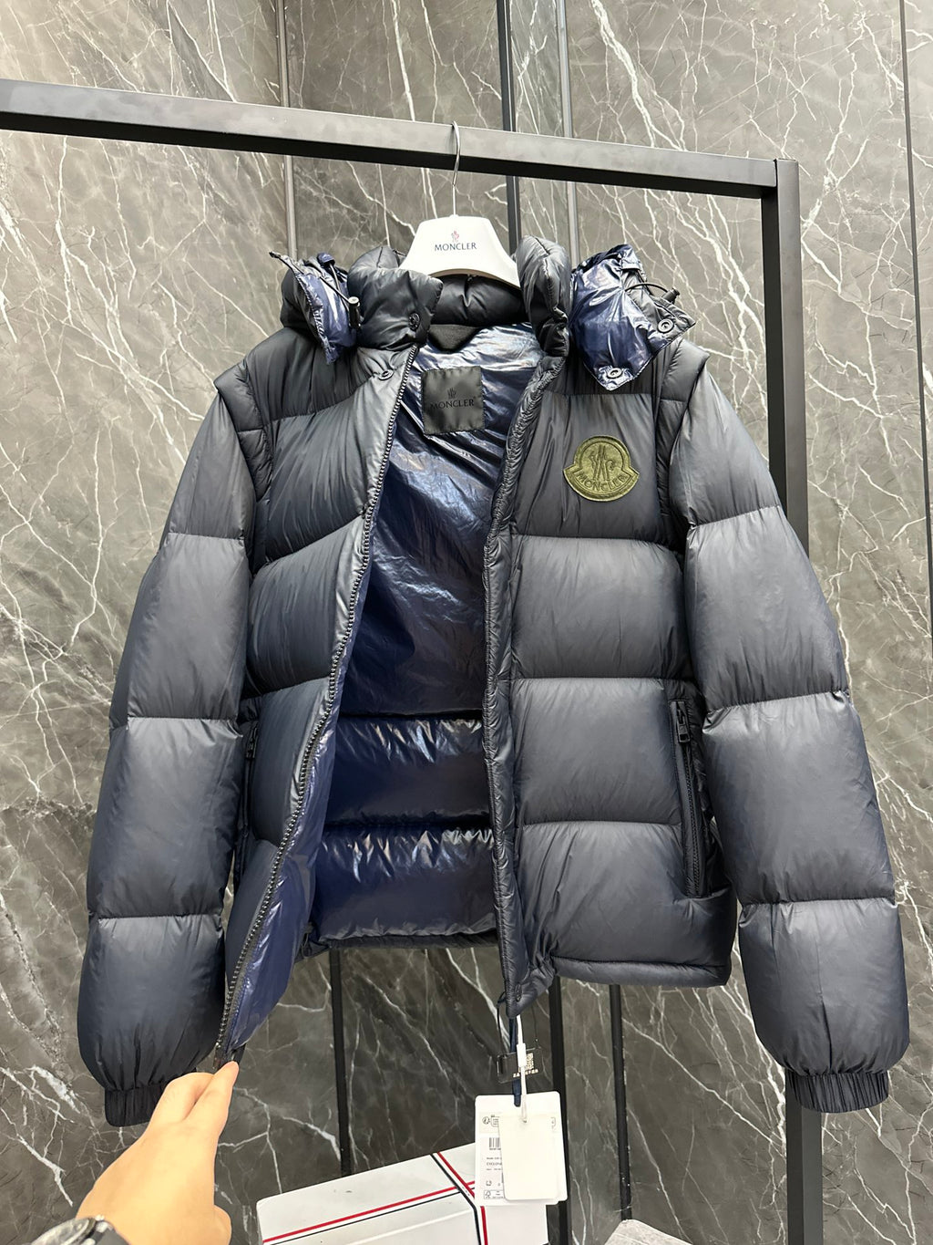 Long hooded puffer jacket with shiny blue lining, logo patch and button front