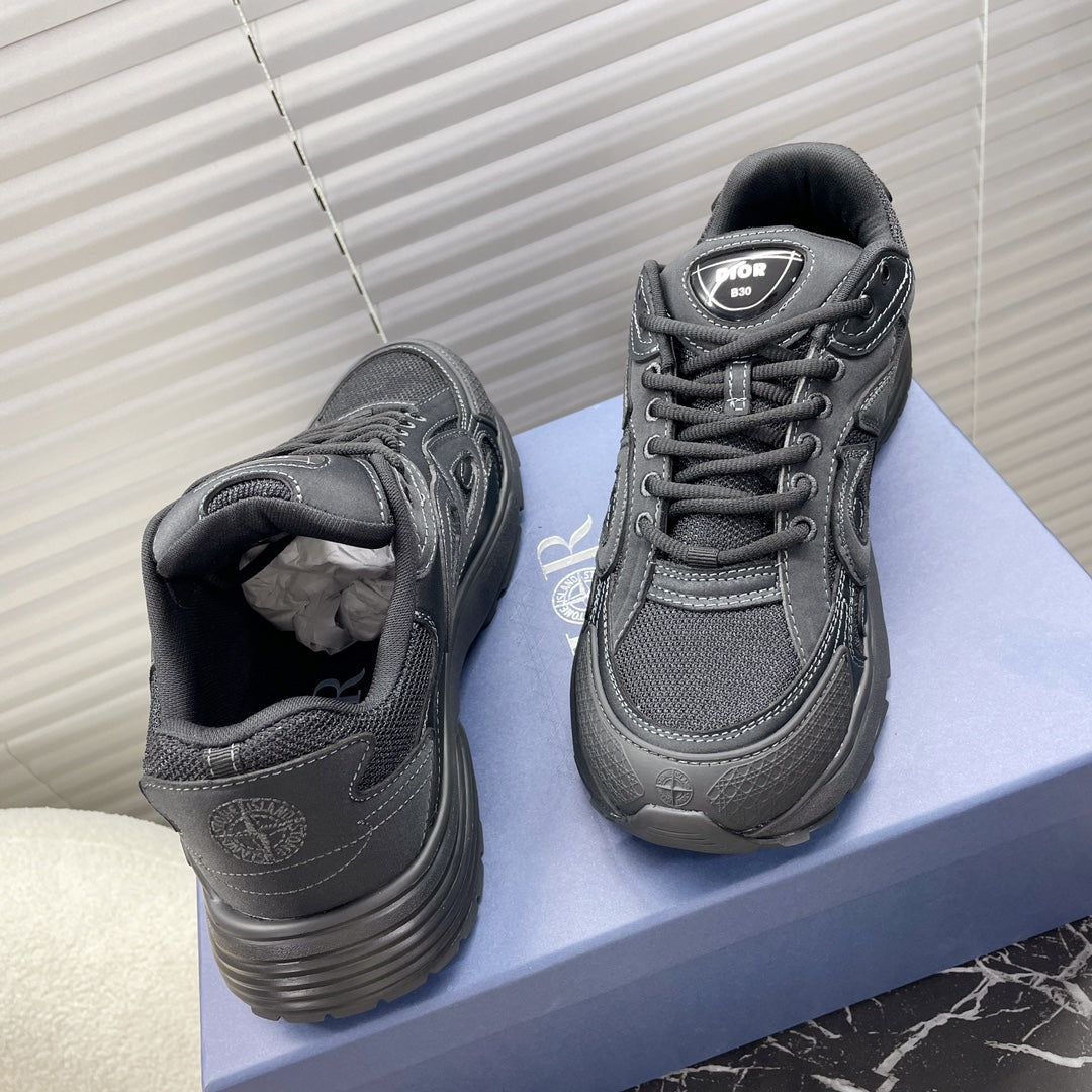 Dior unisex sneakers on box, dark gray lace-up with black padded tongue.