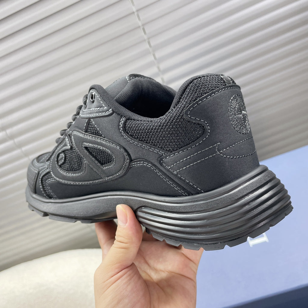 Dior unisex sneakers heel close-up, dark gray with ribbed midsole and logo trim.