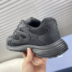 Dior unisex sneakers heel close-up, dark gray with ribbed midsole and logo trim.