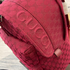 Gucci mini backpack side close-up in burgundy with GG monogram stitching and padded panel