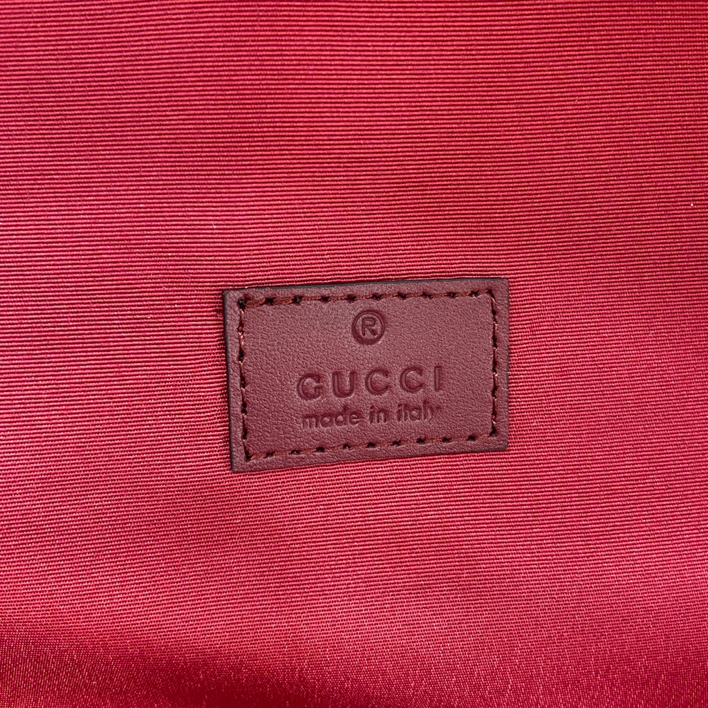 Gucci made in Italy leather label on red bag