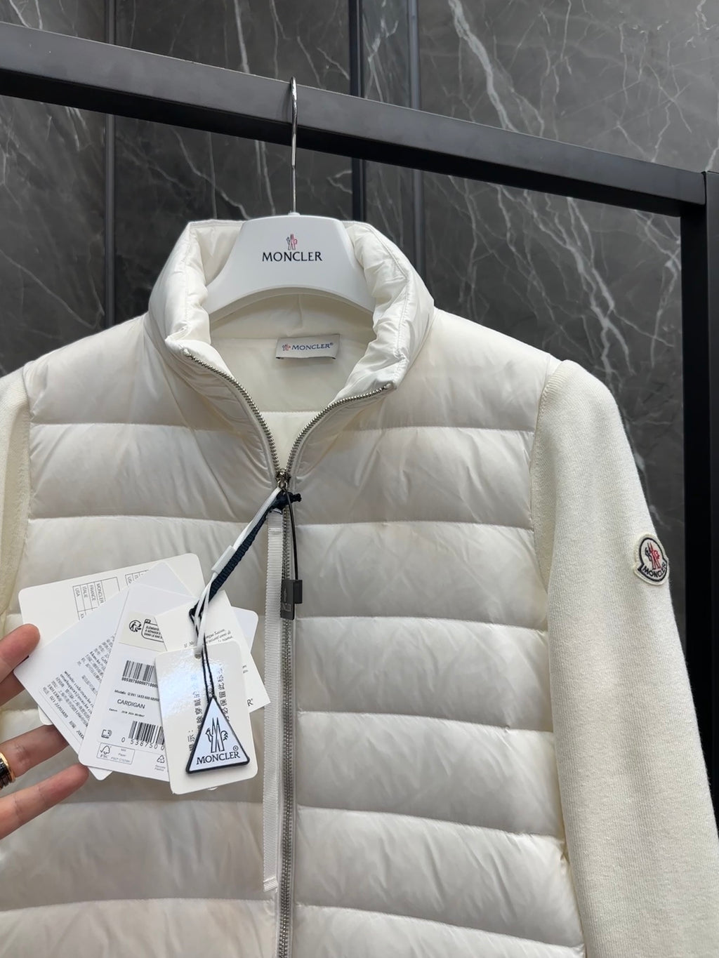Moncler padded jacket close-up, light white quilted front with zipper and collar