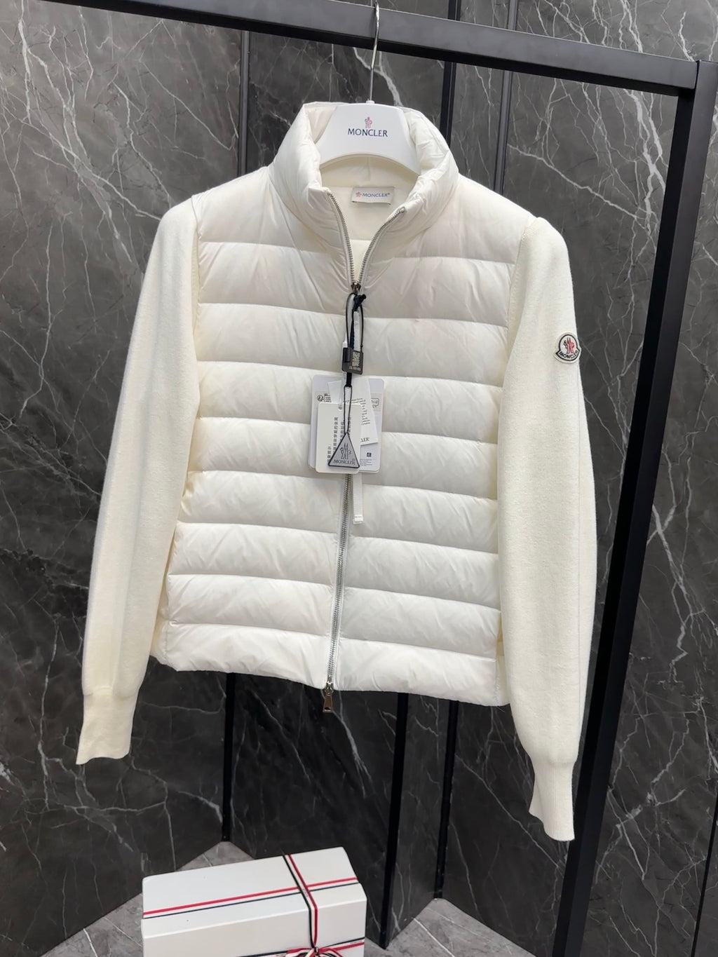 Moncler long padded jacket, light white on hanger with front zip and hanging tag