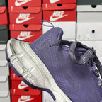 Dark blue knit sneaker with silver textured sole and side laces