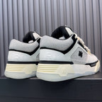 Back view of white and black sneakers with cream sole tread and heel branding.
