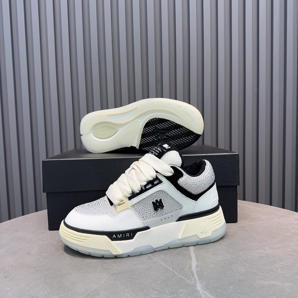 White and black sneaker outsole with cream midsole and lace-up strap.