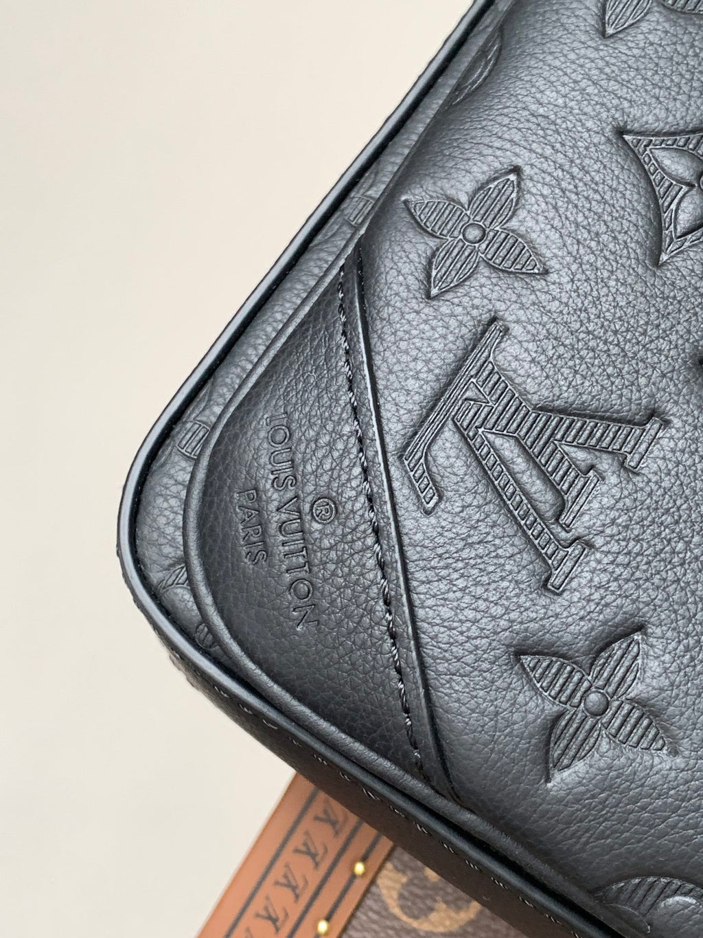 Louis Vuitton monogram bag, dark gray leather, side seam detail and embossed motifs