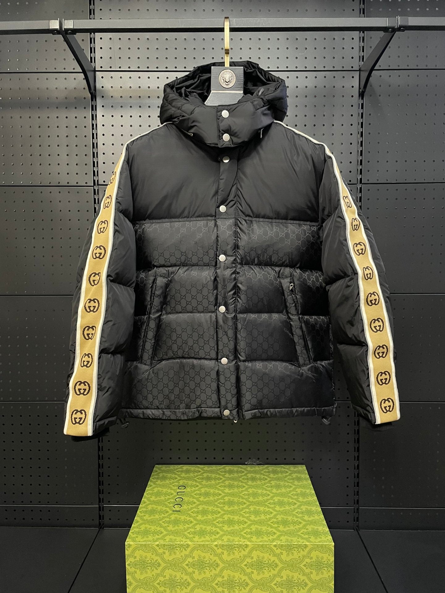 Black hooded puffer jacket with button front and quilted panels