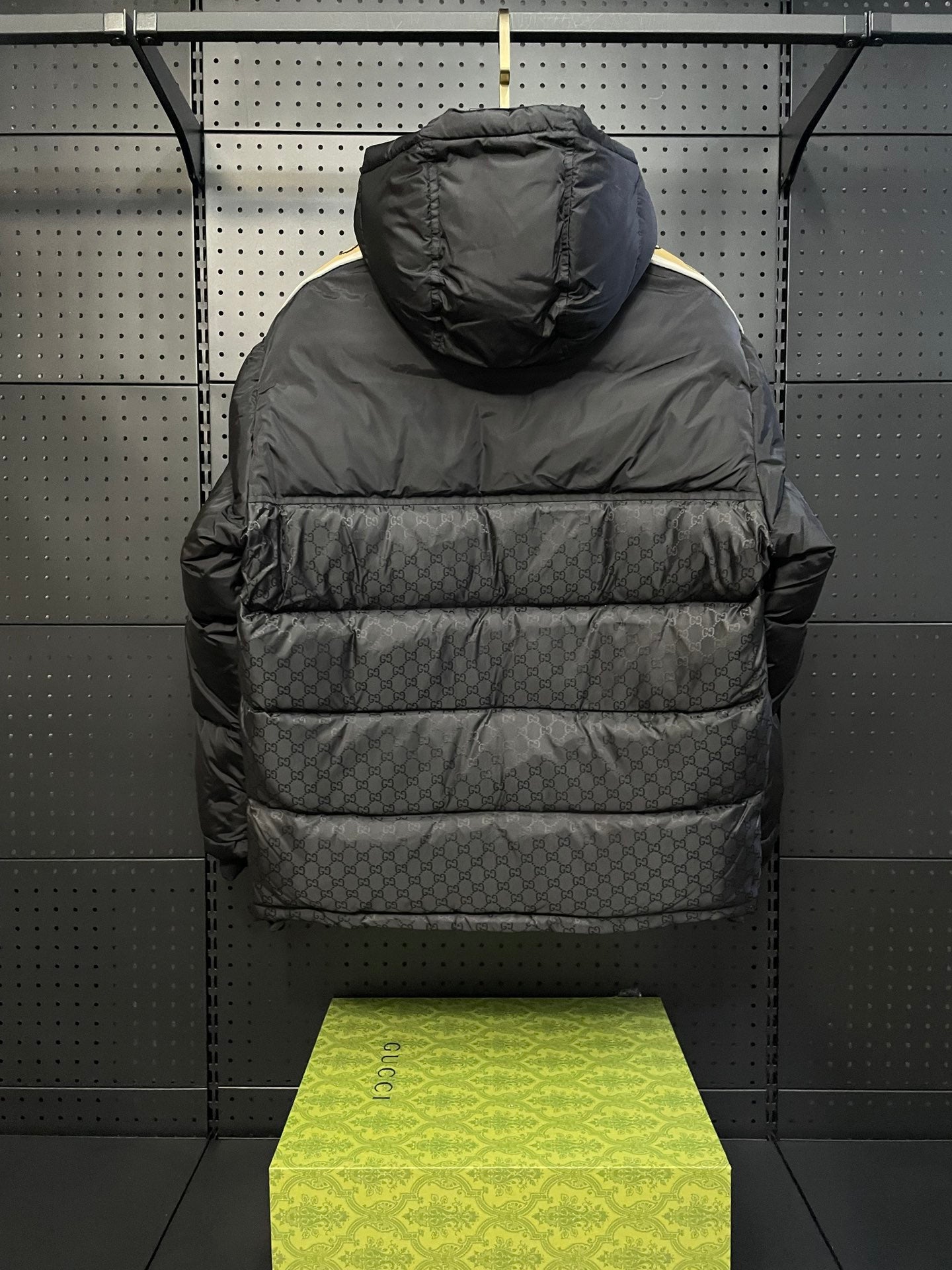 Dark hooded puffer jacket with quilted front and raised collar