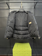 Dark hooded puffer jacket with quilted back and adjustable drawcord hem