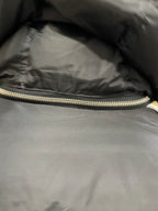 Black puffer jacket interior hem with visible zipper and stitched trim