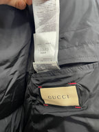Black puffer jacket lining with Gucci tag and care label sewn inside