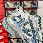 Balenciaga unisex running shoes, front 3/4 view with white mesh and teal graphic details