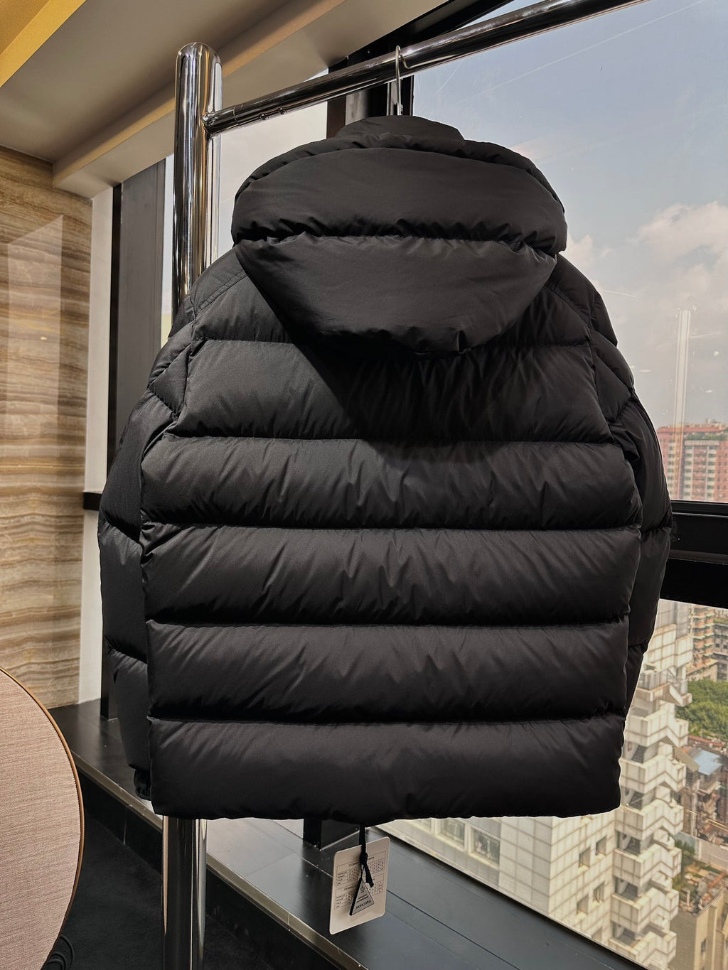 Long puffer jacket in dark black with quilted back and hood