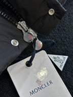 Black puffer jacket front zipper with metal pull and logo snap buttons