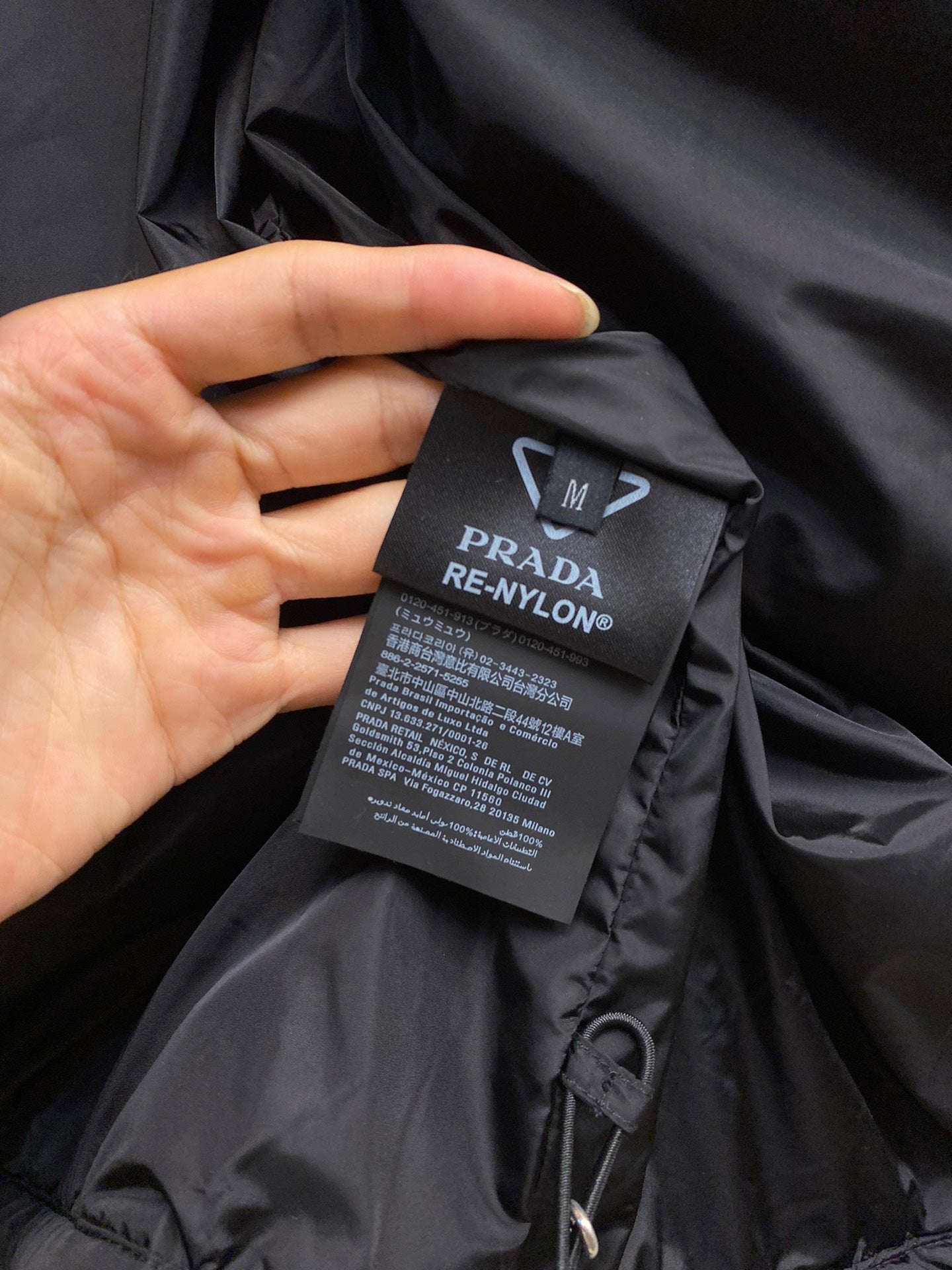 Prada long nylon jacket, dark color, care label attached inside neck area