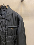 Prada long nylon jacket, dark color, close-up of chest pocket and logo triangle