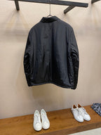Prada long nylon jacket in dark color, back view on hanger
