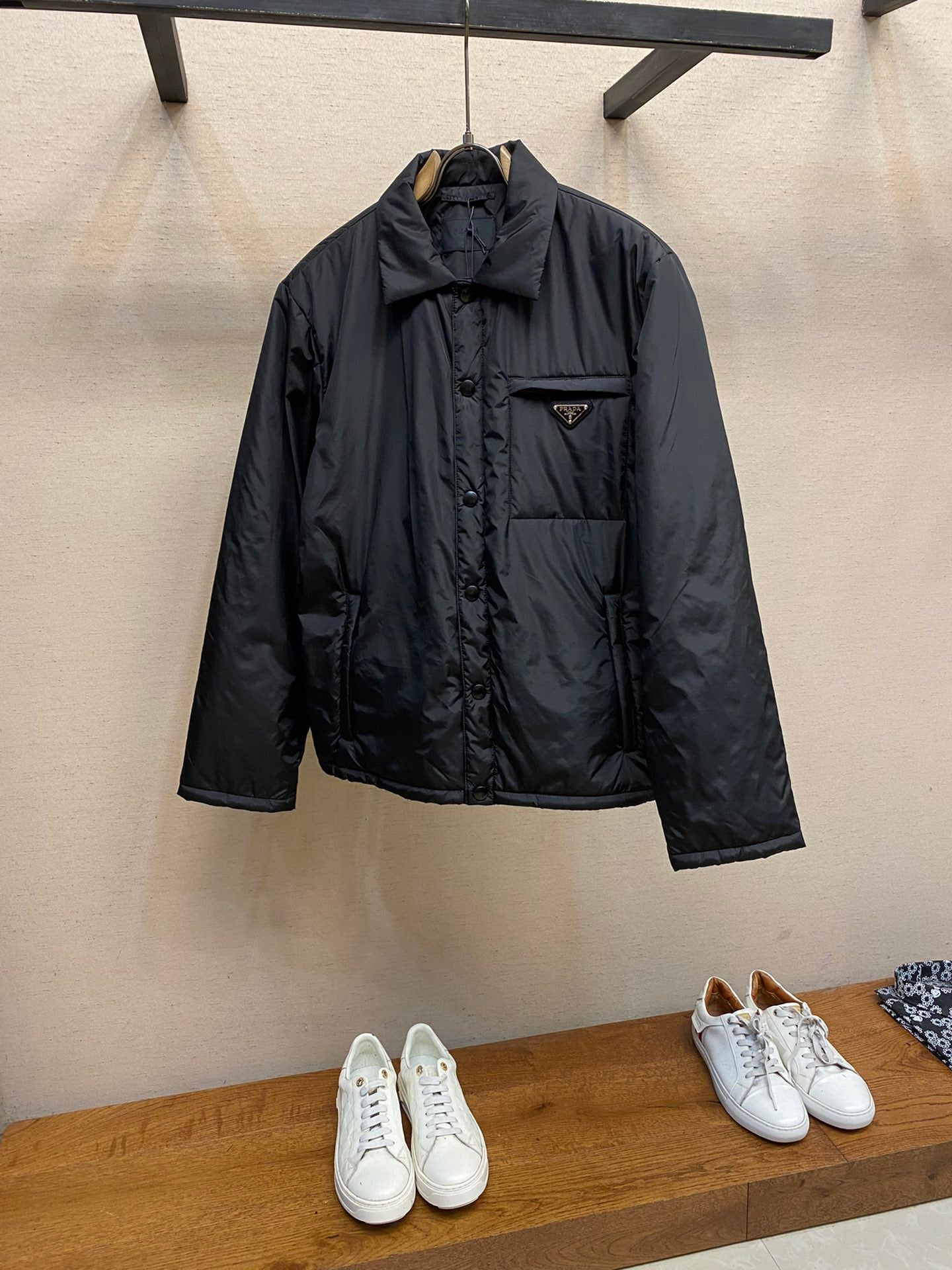 Prada long nylon jacket in dark color, front view with button placket and chest pocket