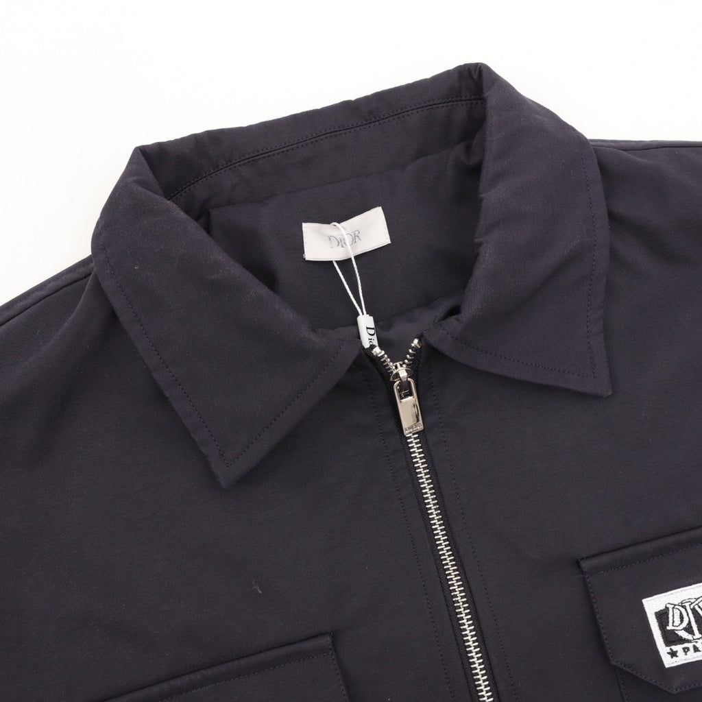 Dior jacket collar and zipper close-up with metal zipper pull and interior label