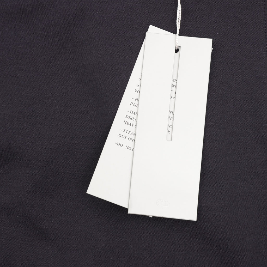 Dior jacket with two white hanging tags on inner upper back