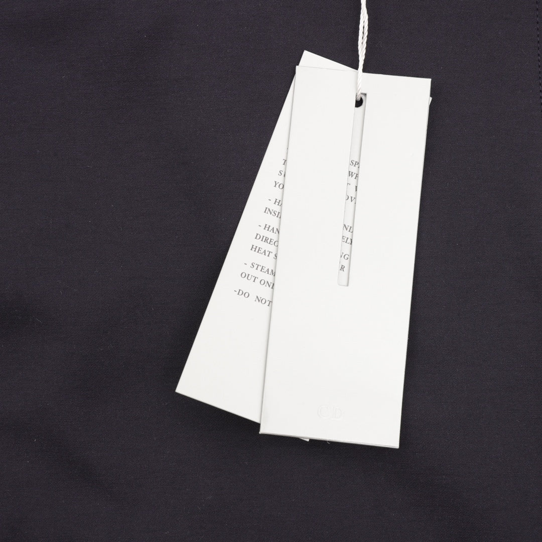 Dior jacket with two white hanging tags on inner upper back