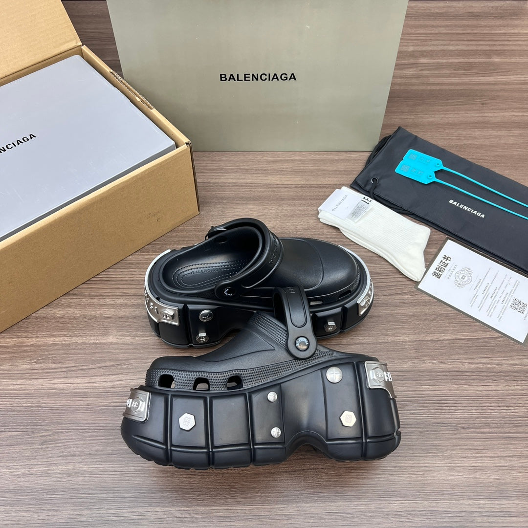 Black Balenciaga sandals with wide strap and visible hardware on chunky platform